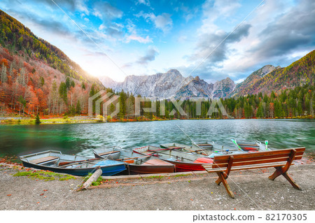 Breathtaking view of sunset over Fusine lake with Mangart peak on background. Breathtaking view of sunset over Fusine lake with Mangart peak on background. 82170305