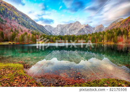 Fabulous view of sunset over Fusine lake with Mangart peak on background. Fabulous view of sunset over Fusine lake with Mangart peak on background. 82170306