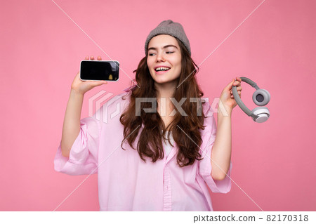 Photo of beautiful positive smiling young woman wearing stylish casual outfit isolated on colorful 82170318