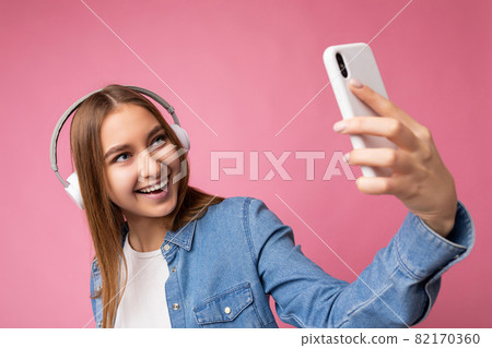 Close-up Photo of beautiful positive smiling young dark blonde woman wearing blue jean stylish shirt Close-up Photo of beautiful positive smiling young dark blonde woman wearing blue jean stylish shirt 82170360