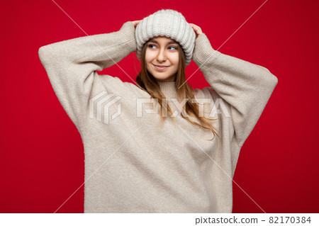 Beautiful positive happy young dark blonde woman isolated over colourful background wall wearing 82170384