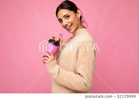 Beautiful young positive brunette woman wearing casual stylish clothes isolated over colorful Beautiful young positive brunette woman wearing casual stylish clothes isolated over colorful 82170999