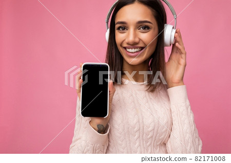 Closeup portrait of attractive positive smiling young woman wearing stylish casual outfit isolated Closeup portrait of attractive positive smiling young woman wearing stylish casual outfit isolated 82171008