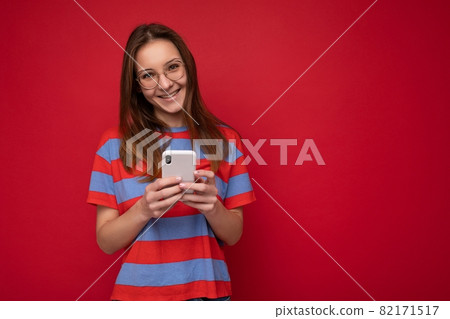 Photo shot of attractive positive good looking young woman wearing casual stylish outfit poising Photo shot of attractive positive good looking young woman wearing casual stylish outfit poising 82171517