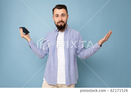 Photo of sad thoughtful handsome good looking young brunette unshaven man with beard wearing casual 82171526