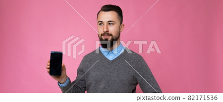 Panoramic photo of handsome happy cool young brunette unshaven man with beardwearing stylish grey Panoramic photo of handsome happy cool young brunette unshaven man with beardwearing stylish grey 82171536