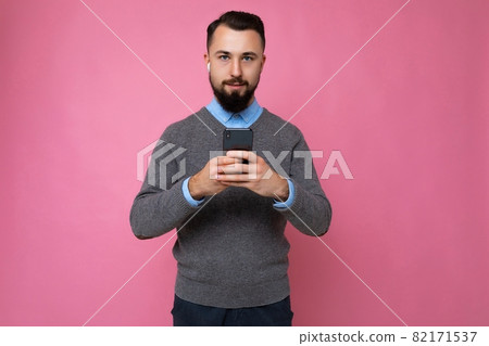 Photo shot of concentrated calm serious handsome good looking young man wearing casual stylish 82171537