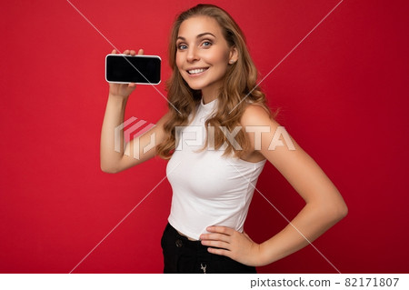 Photo of beautiful smiling young woman good looking wearing casual stylish outfit standing isolated 82171807