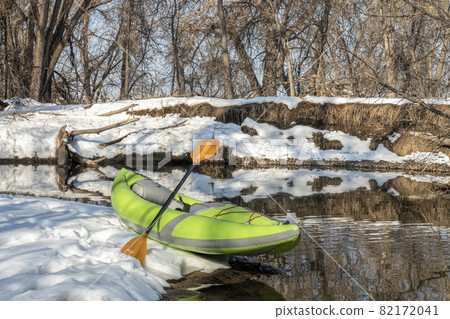 inflatable whitewater kayak on a river shore 82172041