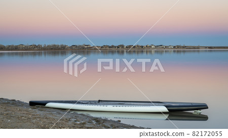 dusk over lake with a paddleboard dusk over lake with a paddleboard 82172055