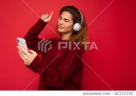 Photo of beautiful joyful smiling young woman wearing stylish casual clothes isolated over Photo of beautiful joyful smiling young woman wearing stylish casual clothes isolated over 82172158