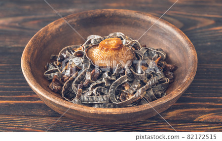 Bowl of black noodles with mushrooms Bowl of black noodles with mushrooms 82172515