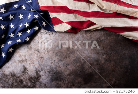 Happy Veterans Day concept. American flags against a dark stone  background. November 11. 82173240