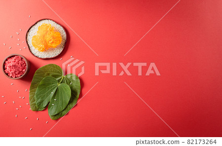 Happy Dussehra. Yellow flowers, green leaf and rice on red background. Dussehra Indian Festival concept. 82173264