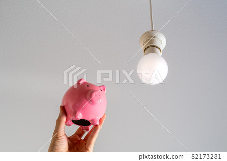 Pink piggy bank and LED lighting hanging from the ceiling Pink piggy bank and LED lighting hanging from the ceiling 82173281