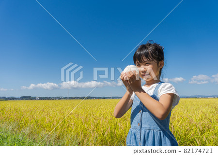 A girl chewing onigiri A girl chewing onigiri 82174721