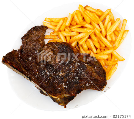 Grilled veal chop with french fries and sauces 82175174