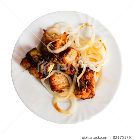 Spicy pork shashlik with fresh onion on plate Spicy pork shashlik with fresh onion on plate 82175179
