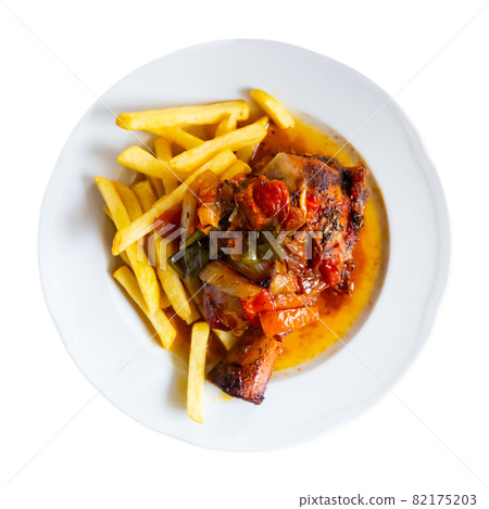 Tasty pork knuckle with potatoes and stewed peppers served 82175203