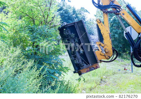 Suburban highway road maintenance service of tractor mechanization machine mower mowing grass Suburban highway road maintenance service of tractor mechanization machine mower mowing grass 82176270