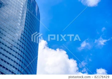 Sky and clouds reflected in the windows of an office building Sky and clouds reflected in the windows of an office building 82176429