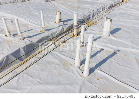 Plastic water pipes industrial pipeline laid on sand foundation at construction site 82176493