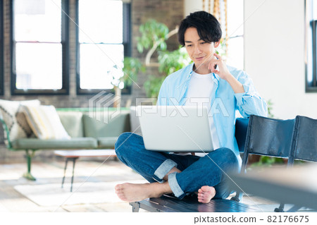 Men's living room telework remote work personal computer lifestyle 82176675