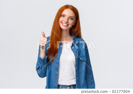 Well done, proud you. Attractive cheerful redhead caucasian girl blogger, review product, encourage friend keep up, showing thumb-up and smiling in approval, agree or like gesture, white background Well done, proud you. Attractive cheerful redhead caucasian girl blogger, review product, encourage friend keep up, showing thumb-up and smiling in approval, agree or like gesture, white background 82177804