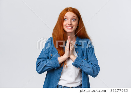 Excited happy cute redhead girl begging for help and receive positive answer, pleading and smiling hopeful feeling relieved friend lend hand with problem, standing white background cheerful 82177983