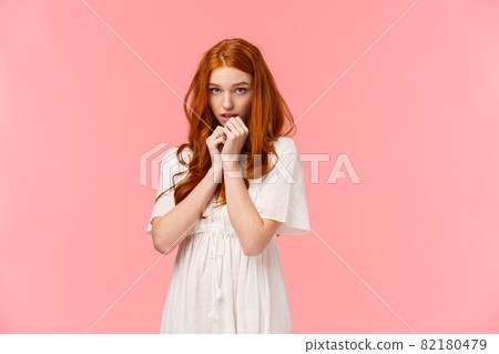 Timid kawaii, redhead european girl in white dress, looking shy and cute, blushing, looking from under forehead indecisive and shy, standing modest over pink background Timid kawaii, redhead european girl in white dress, looking shy and cute, blushing, looking from under forehead indecisive and shy, standing modest over pink background 82180479