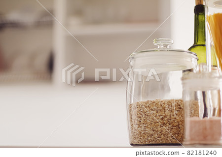 Food products in glass jars in the kitchen, pasta, cereal, salt, wine, groceries Food products in glass jars in the kitchen, pasta, cereal, salt, wine, groceries 82181240