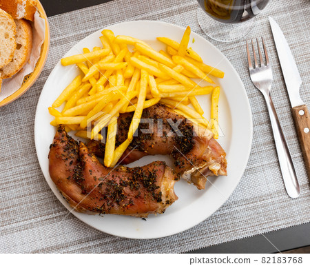 Spicy baked pig trotters with french fries Spicy baked pig trotters with french fries 82183768
