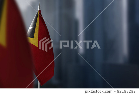 Small flags of East Timor on a blurry background of the city Small flags of East Timor on a blurry background of the city 82185282