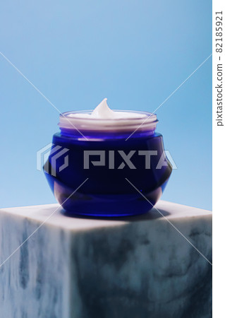 Anti-aging skincare and cosmetics, beauty face cream in jar on blue background 82185921