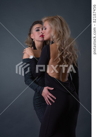 Two young attractive women with problem skin faces posing in studio 82187456