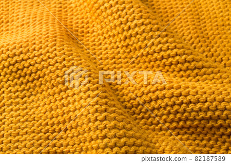 yellow knitted fabric with folds, close-up, selective focus yellow knitted fabric with folds, close-up, selective focus 82187589