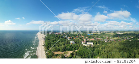 Baltic sea coastline and green summer forest with Yantarny town . Aerial panorama view 82192204