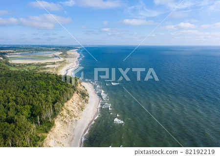 Baltic coastline with green summer forest and the sea. Aerial view from drone Baltic coastline with green summer forest and the sea. Aerial view from drone 82192219