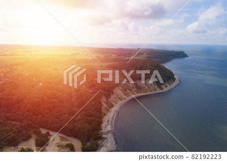 Baltic sea coastline and green summer forest on sunset . Aerial view 82192223