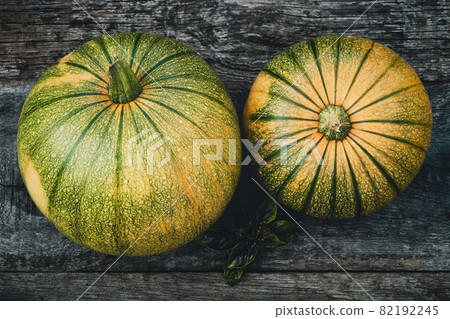 Pumpkins top view on old wooden board Pumpkins top view on old wooden board 82192245