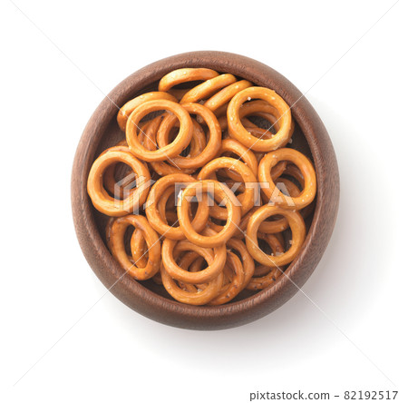 Wooden bowl of salty crispbread wheat mini rings 82192517