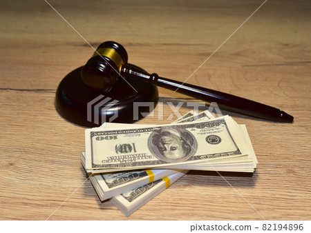 Judge hammer and bundles of dollars. Justice in courtroom. Mallet of judge on law theme  82194896