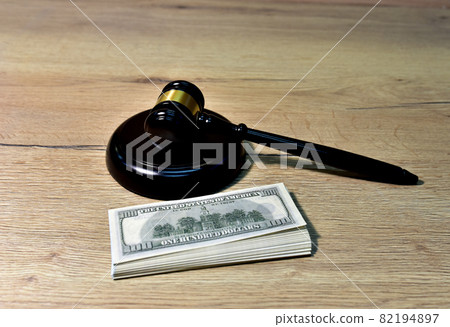 Judge hammer and bundles of dollars. Justice in courtroom.  82194897