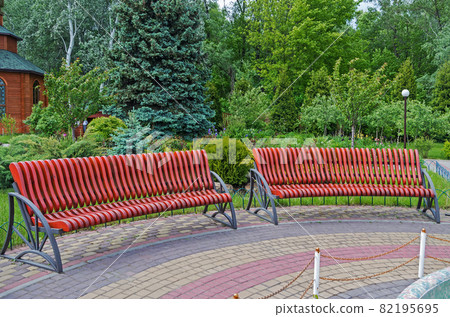 Benches in landscaped courtyard garden of the church 82195695