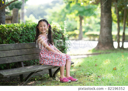 Young Girl Sitting On A Park Bench Stock Photo Image Of A Girl Is