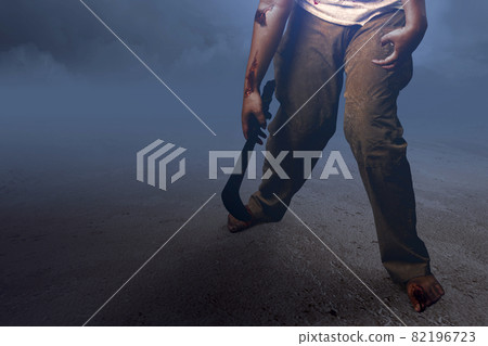 Scary zombie with blood and wound on his body holding sickle walking 82196723