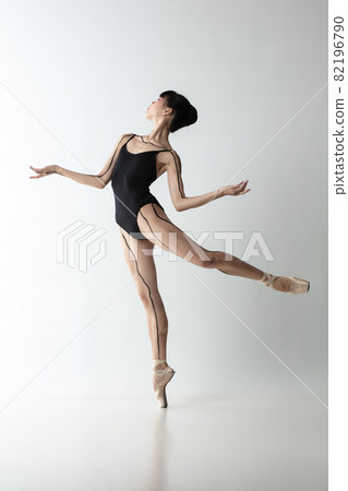 Full-length portrait of graceful ballet dancer, ballerina dancing isolated on light gray studio background. Art, motion, action, flexibility, inspiration concept. Full-length portrait of graceful ballet dancer, ballerina dancing isolated on light gray studio background. Art, motion, action, flexibility, inspiration concept. 82196790