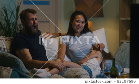 Diverse family discussing film on sofa 82197690
