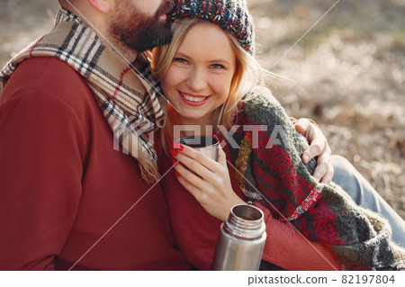 Couple sitting by the tree in a spring forest 82197804