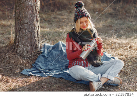 Girl sitting by the tree in a spring forest Girl sitting by the tree in a spring forest 82197834